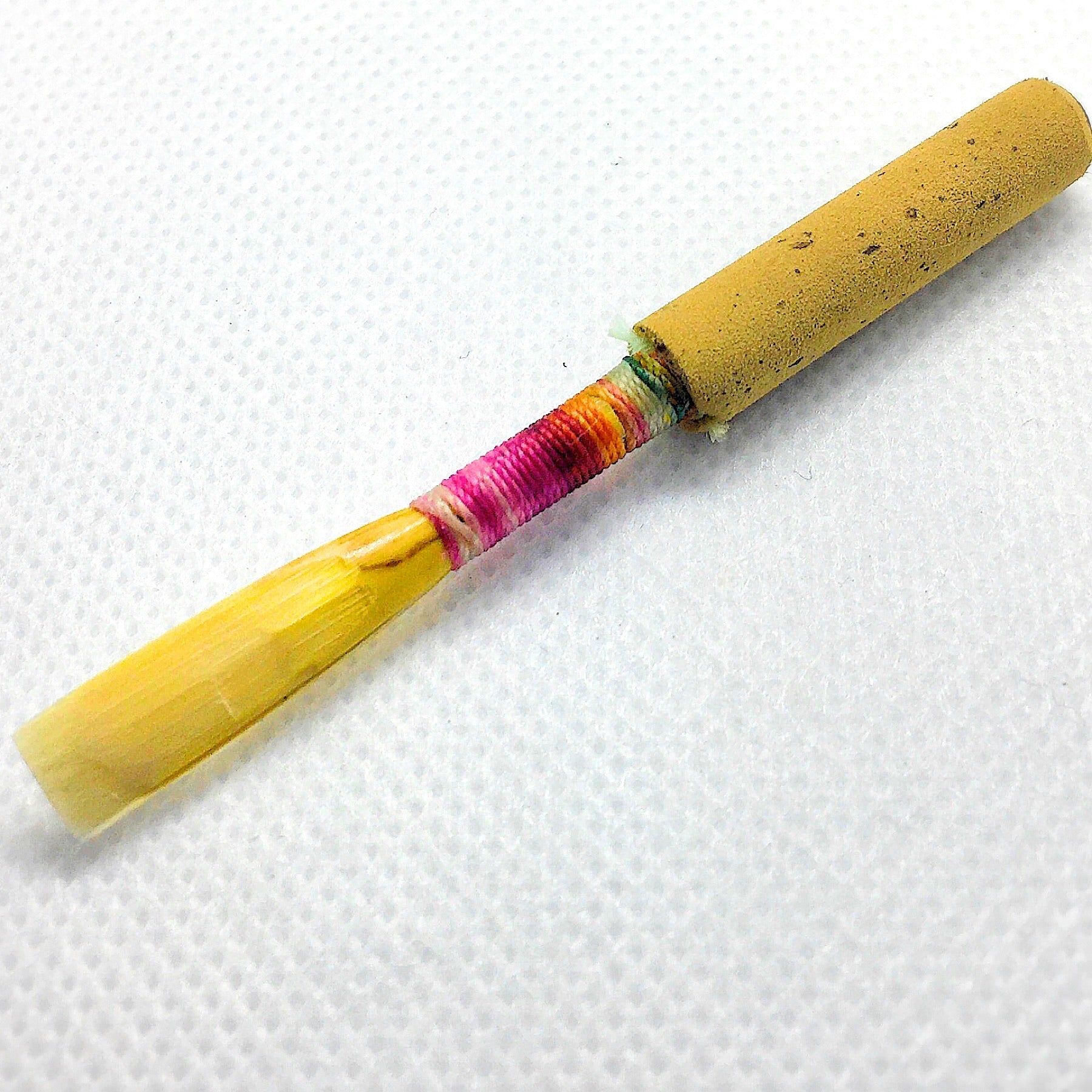 a handmade oboe reed on a white background. Professional level oboe reed made by mallar oboe reed. 